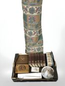 A large roll of floral fabric, box of table boxes, knitting needles,