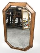An Edwardian oak octagonal bevelled mirror, width 75 cm.