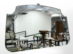 An Art Deco frameless mirror, width 68 cm.