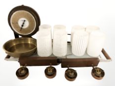 A group of 1970s teak wall lights with frosted glass shades, a hot tray and a wall mounted scale.