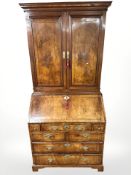 A George II figured walnut and satinwood-banded bureau bookcase, circa 1750,