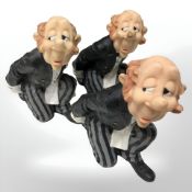Three resin bottle stands in the form of butlers, height 16 cm.