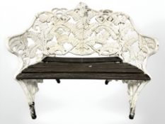 A late Victorian painted cast iron and teak two seater garden bench in the manner of Coalbrookdale,