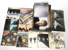 A collection of The Beatles and John Lennon vinyl LP records.