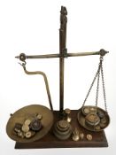 A set of mahogany and brass balance scales with various graduated weights, height 45 cm.