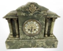 An onyx and gilt metal eight day mantel clock with enameled dial, height 30 cm.