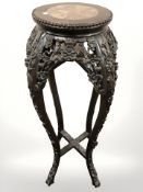 A 19th century Chinese carved hardwood and marble inset jardiniere stand, height 91 cm.