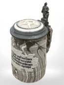 A Sarreguemines agate ware tankard with pewter mounted figural finial hinged lid,