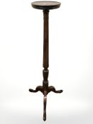 A 20th century mahogany torchere,