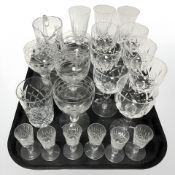 A group of crystal drinking glasses including three Edinburgh Crystal champagne flutes,