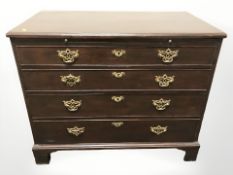 A George III oak four drawer bachelor's chest with brushing slide,