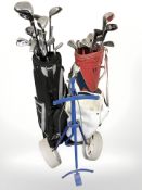 A golf trolley and two bags of irons and drivers including Dunlop, Wilson,