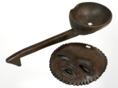 An African carved hardwood tribal mask and a large spoon,