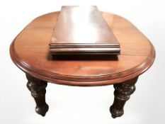 A Victorian style mahogany oval extending dining table with two leaves,
