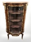 A late-19th century French walnut and gilt metal mounted serpentine front vitrine,