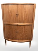 A 20th century teak bow front corner cocktail cabinet, height 143 cm.
