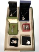 A group of silver pendants and brooches including Scottish thistle brooch, Viking long ship pendant,