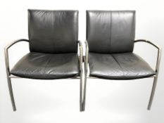 A pair of contemporary chrome and black leather lounge armchairs,
