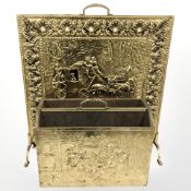 An embossed brass fire screen,