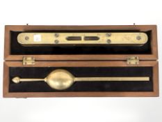 A rosewood and brass spirit level and a boxed hydrometer.