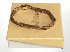 A 9ct gold triple strand bracelet, length 19 cm. CONDITION REPORT: 18.