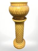 A Victorian glazed earthenware jardiniere on stand, height 116 cm.