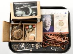 A group of silver and other rings, amber coloured necklace, model scooter,