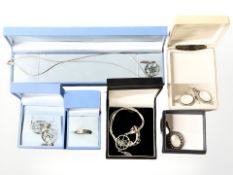 A group of silver pendants, two pairs of earrings and a ring.