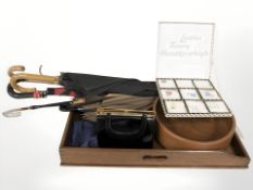 A mahogany cutlery tray containing several umbrellas, turned wooden fruit bowl, purse,