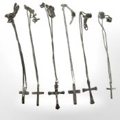 Silver silver crucifix pendants on chains.