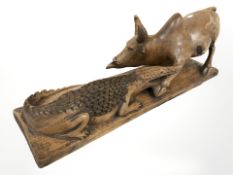A carved hardwood figure of an ox and crocodile, length 49 cm.