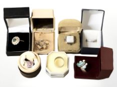 A group of silver rings set with various coloured stones, amber, etc.