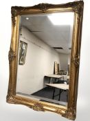 A reproduction gilt framed mirror, 109 cm x 77 cm.