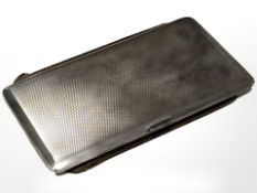 A large silver cigarette case with engine turned decoration, Birmingham marks, 17 cm x 9 cm.
