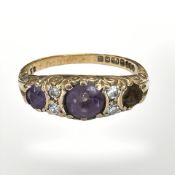 An 18ct yellow gold ring set with amethyst and diamonds, size O. CONDITION REPORT: 4.