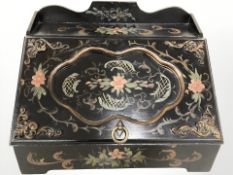 An ebonised and hand painted tabletop box, width 38 cm.