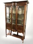 An Edwardian bow-front display cabinet,