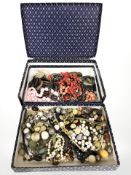 A two division box of assorted costume necklaces, simulated pearls, etc.