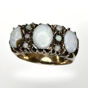 A 9ct yellow gold ring set with opals, size P CONDITION REPORT: 4.6g.