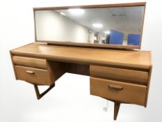 A Chapman's Siesta teak twin pedestal mirror back dressing table, 156 cm W x 42 cm D x 116 cm H.