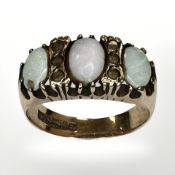 A 9ct yellow gold ring set with opals, size P/Q. CONDITION REPORT: 4.