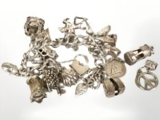 A silver charm bracelet. CONDITION REPORT: 80.