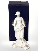 A Royal Crown Derby porcelain figure of a lady carrying a lamb, height 23 cm, with box.