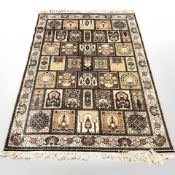 A machine made rug of Ghom design,