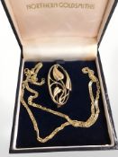 A 9ct gold twist link necklace, length 40 cm, and a 9ct gold Art Nouveau style brooch.