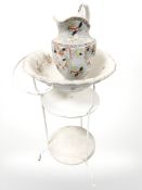 A wrought metal wash stand and a pottery wash jug and basin.