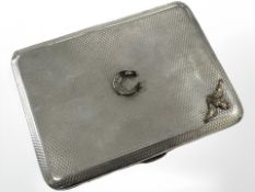 A silver cigarette case with applied RAF emblem and horseshoe, Chester 1929.