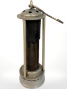 A miner's lamp with central gauze lining.