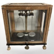 A J W Towers & Co. balance scale in glazed oak case, width 42 cm.