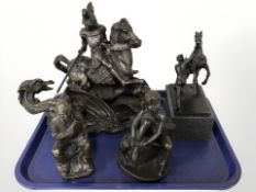 A patinated metal statue of a man and a rearing horse,